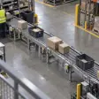Worker sorting cartons on a warehouse conveyor