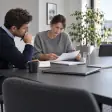 Colleagues reviewing documents around an office table