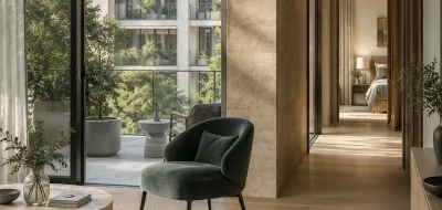 Sunlit apartment living room with a green armchair